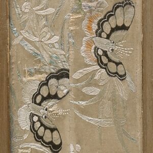 Embroidered beige textile runner featuring detailed white flowers, black butterflies, and birds, framed in wood.