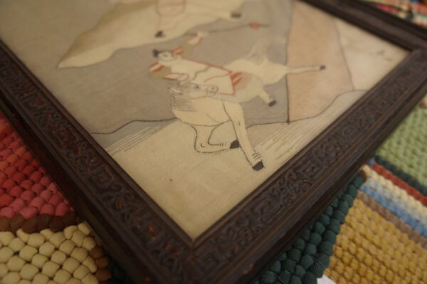 Textured area rug with alternating bands of red, cream, dark green, and yellow bobble weave.