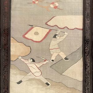 Framed tapestry in grays, tan, and red depicting two figures against an abstract background within a carved wood frame.