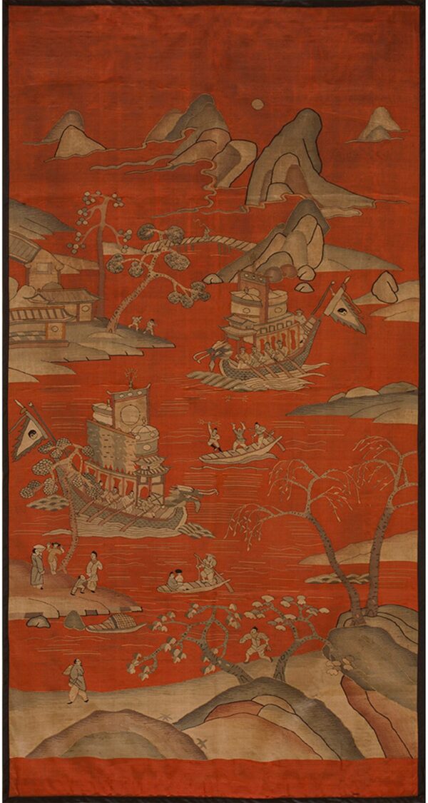 A vertical oriental style rug depicts a detailed river scene with ships, figures, and mountains on a vibrant red ground.