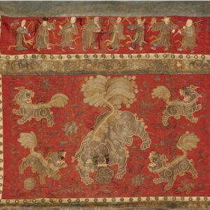 Red embroidered textile displaying gray and gold mythical beasts, bordered by dancing figures and floral motifs.