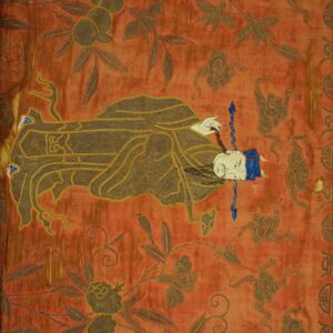 Low-pile rust textile with gold and brown embroidery showing a reclining figure and floral motifs.