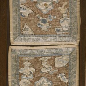 Highly textured brown and gold embroidered textile panels displaying blue and cream figural cartouches, framed in wood.
