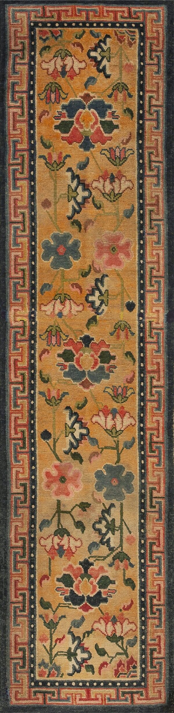 Golden yellow runner rug displaying multicolored florals and a geometric key border surrounded by dark blue.