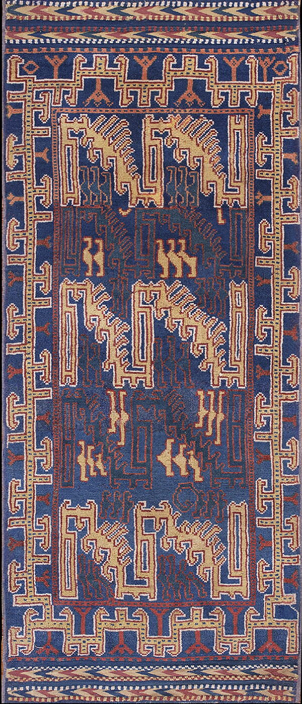 Vertical blue rug with tan and rust tribal geometric patterns, including stylized animal figures and borders.