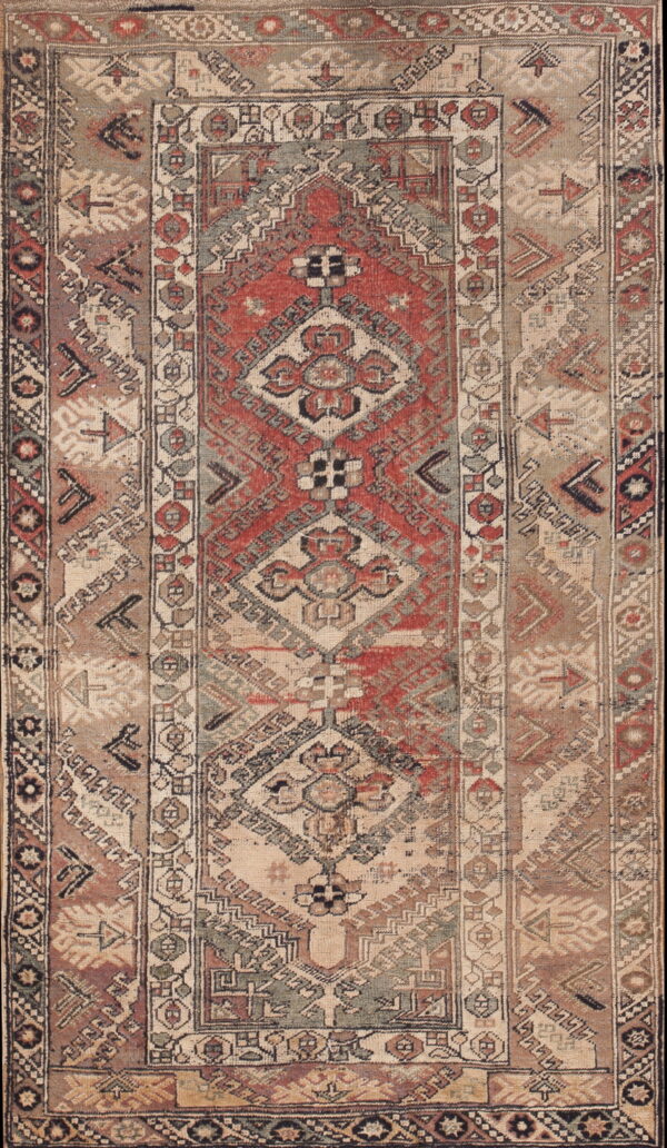 Geometric low pile rug with a central medallion in faded red, beige, gray, and brown colors.