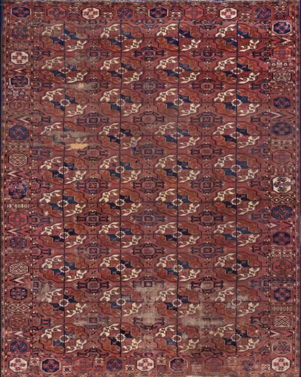 Distressed, low-pile rug featuring a geometric lattice pattern in deep red, navy blue, and cream.