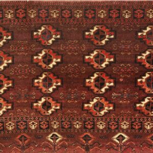 Reddish-brown rug with complex geometric patterns and repeating medallions in rust, cream, and navy.
