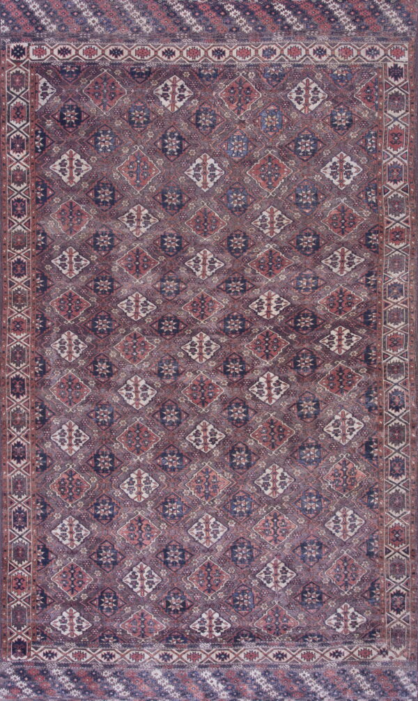 Muted purple, navy, and terracotta rug with an all-over repeating geometric diamond pattern and structured border.