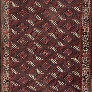Deep brown rug with repeating geometric tribal patterns in rust, cream, and dark blue.
