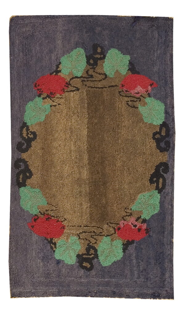 Dark blue hooked rug with a brown central field and red and mint green floral scrolling motifs.