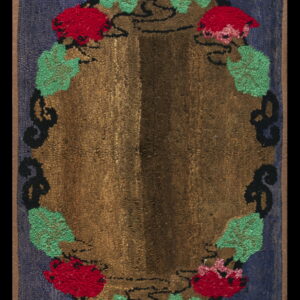Navy blue hooked rug with a central brown oval medallion decorated with red flowers and green leaves.