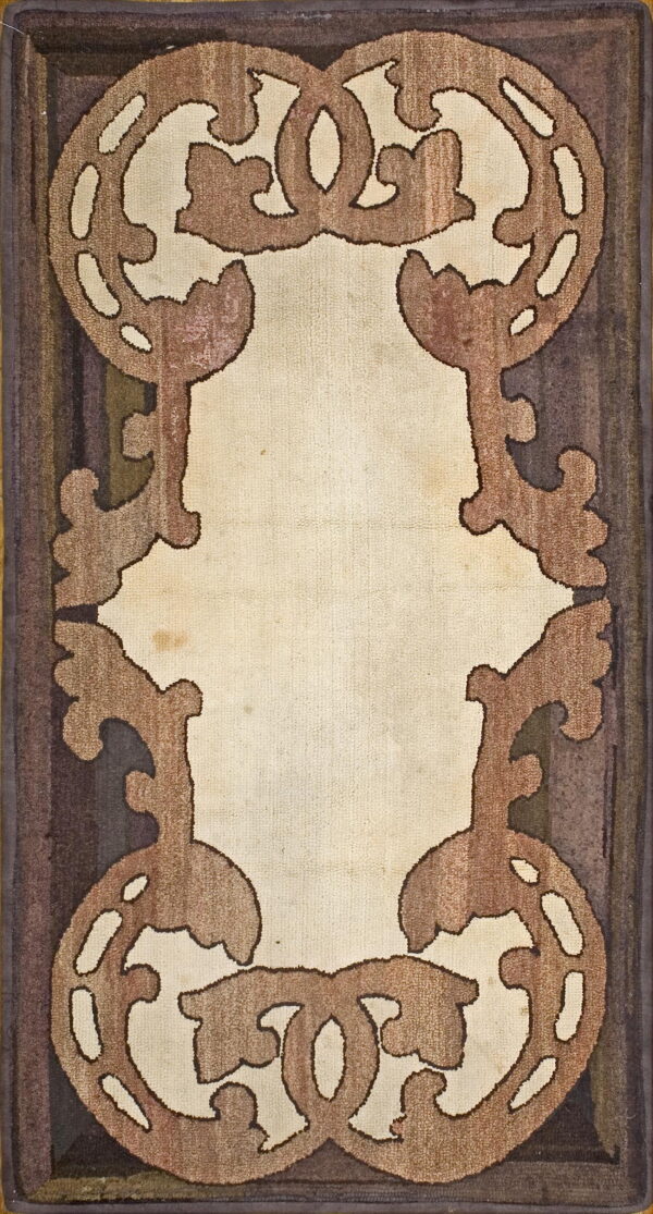 Rectangular rug with a light beige center field framed by ornate brown scrolling motifs and a dark striped border.