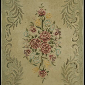 Textured sage green rug centered with a colorful floral bouquet and framed by scrolling olive leaves.