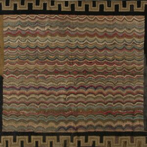 Textured rug with multicolored wavy bands in earth tones and a thick geometric Greek key border.