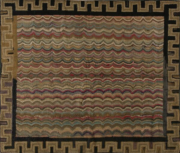 Textured rug with multicolored wavy bands in earth tones and a thick geometric greek key border.