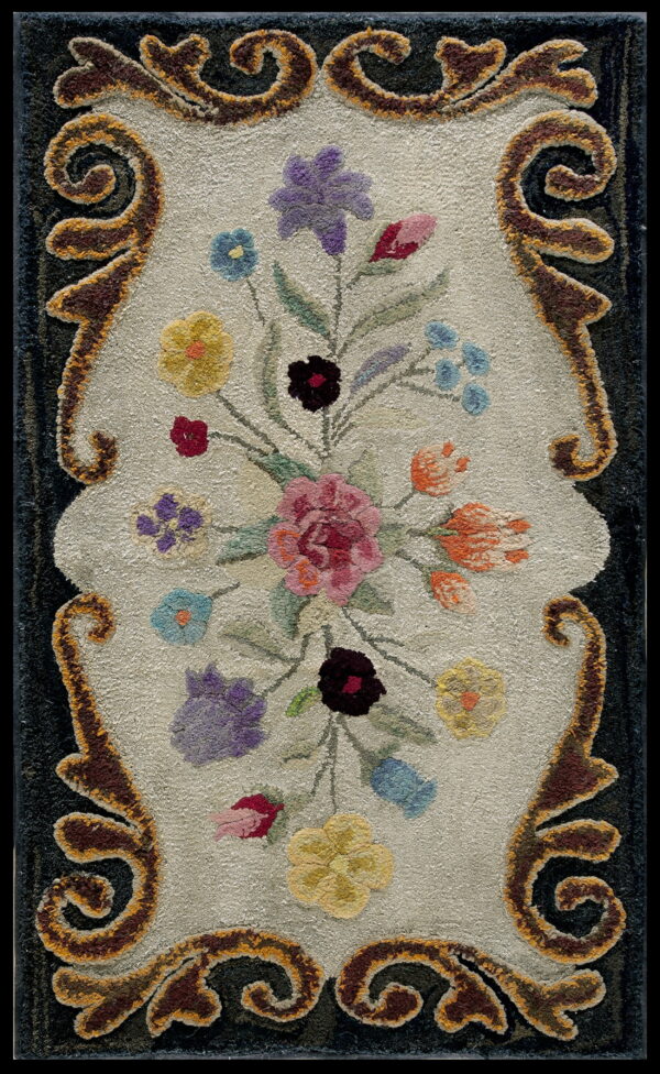 Sculpted rug featuring a multicolored floral bouquet on a light center field framed by dark brown scrolling motifs.