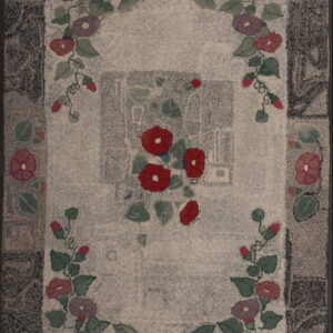 Hooked rug with a light gray field, a dark border, and colorful floral garland motifs in red, blue, and green.