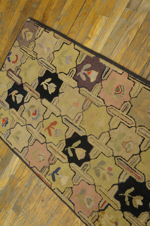 Muted yellow runner with black, pink, and purple geometric floral shapes shown on aged wood planks.