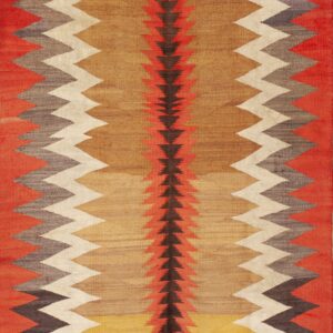 Flat woven rug in red, tan, and brown featuring vertical zigzag borders and a central arrow pattern.