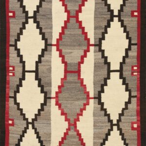 A flatwoven textile with vertical stepped diamonds in cream, variegated gray, black, and red.