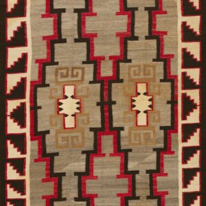 Gray flatweave rug with a dark brown, red, and tan interlocking geometric pattern and stepped borders.