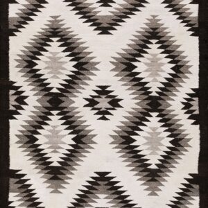 Flatweave rug with a black and gray serrated diamond pattern on a white background and dark border.