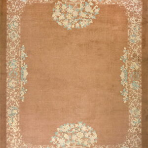 Terracotta rug featuring intricate cream, pale blue, and pink traditional floral and geometric motifs.