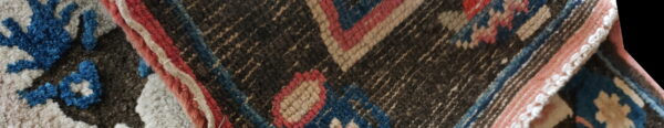 Close-up shows a contrasting rug design with shaggy blue and white pile next to geometric stripes.