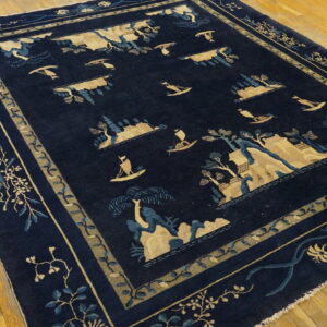 Navy rug with tan and blue islands, trees, and boats, framed by a floral border on wood planks.