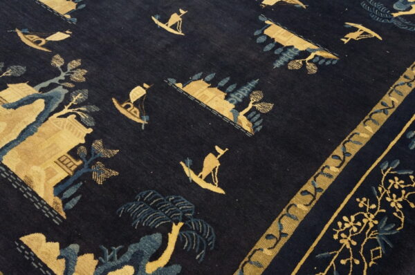 Deep navy rug featuring golden tan and pale blue motifs of boats, trees, and buildings.