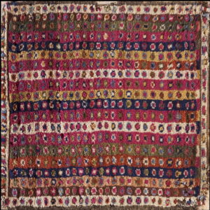 High pile rug featuring colorful horizontal bands filled with small, repeating medallion designs.