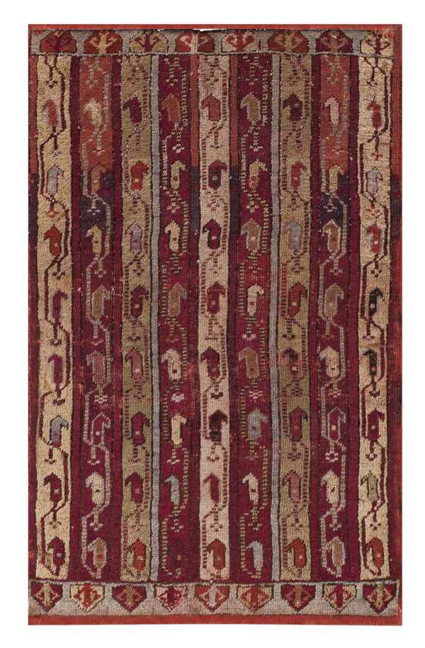 Red, tan, and gray rug with vertical striped bands containing stylized abstract figures.