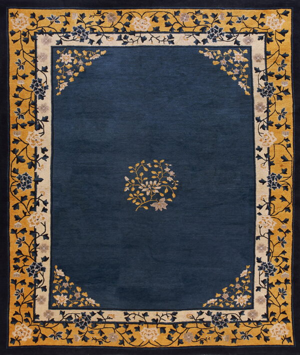 Navy blue rug featuring a large gold and cream border with intricate, stylized floral scrollwork.
