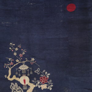 Deep blue pictorial rug with a red sun, blossoming branches, a hanging lantern, and gray landscape details.
