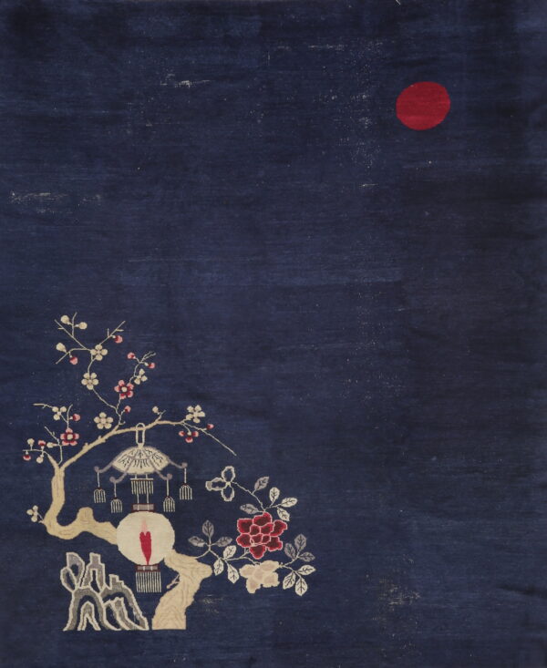 Deep blue pictorial rug with a red sun, blossoming branches, a hanging lantern, and gray landscape details.