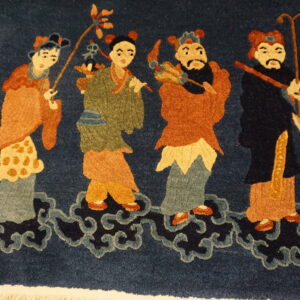 Deep blue high-pile rug with rust, gold, and sage figures standing on stylized navy cloud motifs.