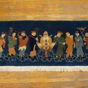 Navy blue rug featuring ten colorful figures standing on cloud designs, displayed on honey-toned wood floors.