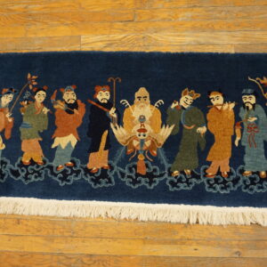 Plush navy rug depicting colorful figures on clouds, visible on light brown wood plank flooring.