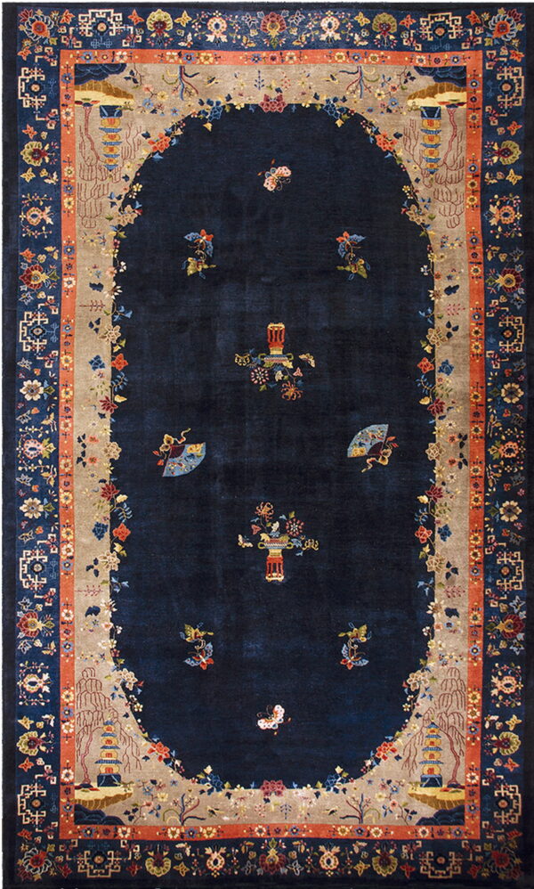 Dark navy rug with a detailed oval beige border featuring pagodas, flowers, and terracotta accents.
