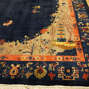 Detailed navy rug with a pagoda and landscape scene, bordered by rust-orange and floral geometric patterns.