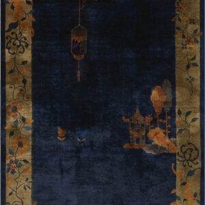 Navy blue rug with an olive border patterned with flowering branches, a lantern, and a scenic pavilion.