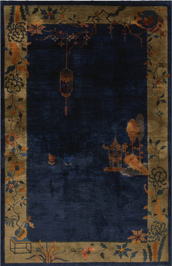 Navy blue rug with an olive border patterned with flowering branches, a lantern, and a scenic pavilion.
