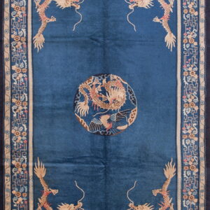 Dark blue rug with tan dragon motifs, a central medallion, and an ornate tan and blue border.