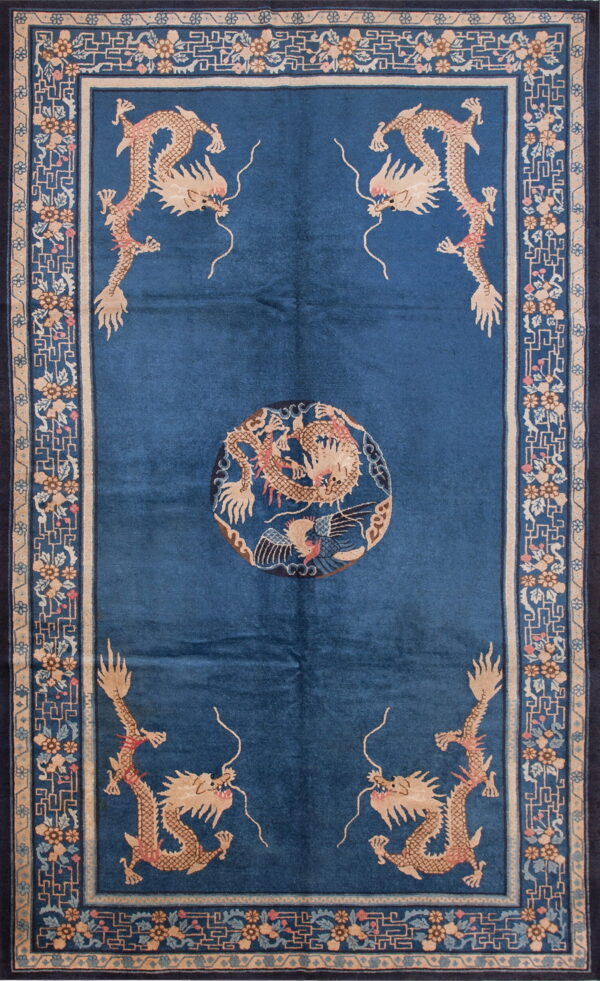 Dark blue rug with tan dragon motifs, a central medallion, and an ornate tan and blue border.