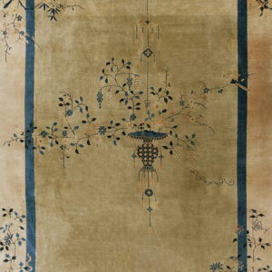 Olive rug with a central stylized vase and floral motif within a dark blue border.