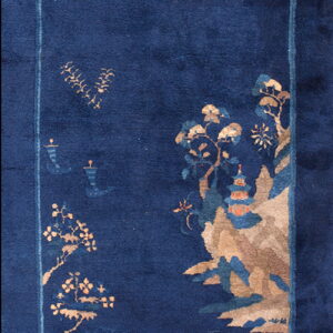 Deep blue runner rug featuring an asymmetrical scenic landscape design with tan mountains, trees, and a subtle border.