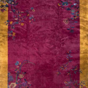 Plush magenta rug with a wide mustard yellow border and colorful corner botanical designs.