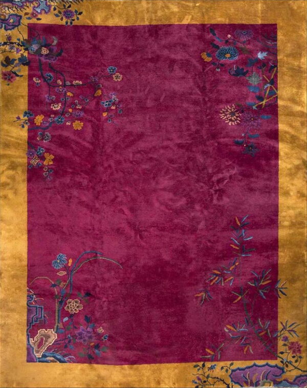 Plush magenta rug with a wide mustard yellow border and colorful corner botanical designs.