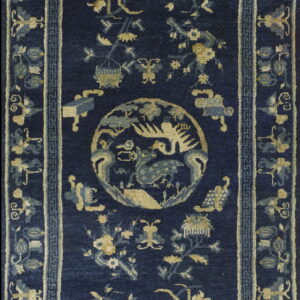 Deep navy blue rug featuring a central medallion and scattered traditional floral and animal motifs in beige and light blue.